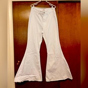 Plus size women’s pure white bell bottom jeans.